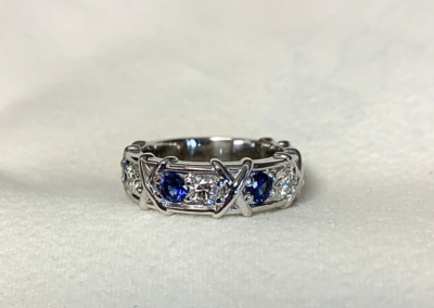 Luxury custom yellow gold ring with blue sapphire accent, handcrafted in Leduc, AB