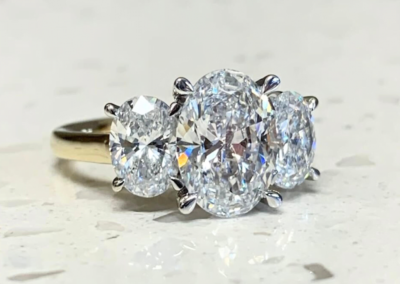 Custom white gold oval diamond cluster engagement ring in Leduc, AB
